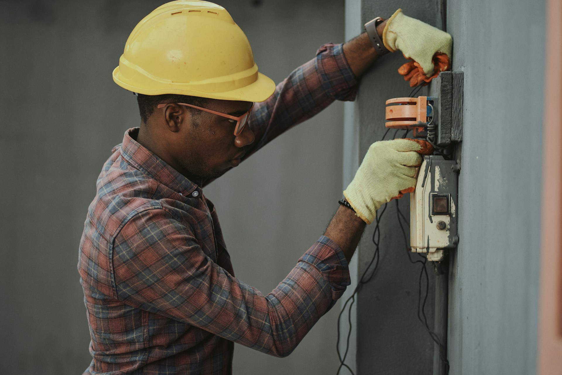 Electrician installing power wiring on a job site