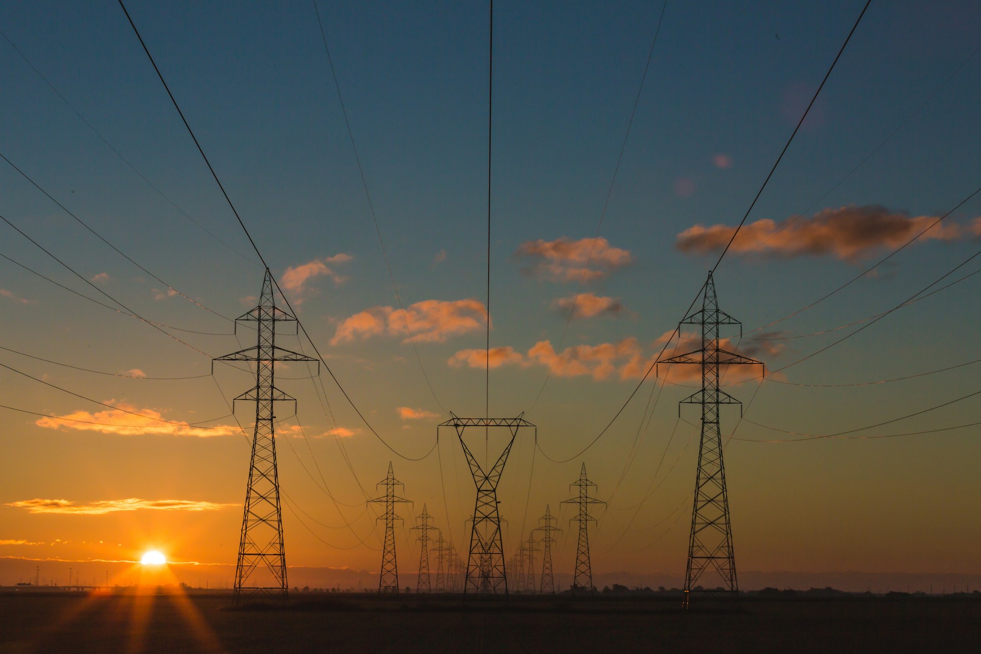 High-voltage transmission lines at sunset